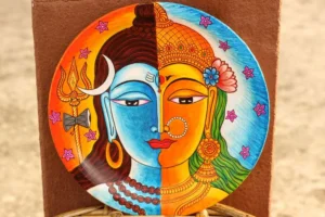 Circular decorative wall plate with split-face motif in orange and blue tones, featuring crescent moon, trident, ornate crown, and elaborate jewelry details, di